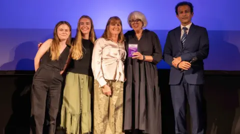 The Nai's House team receiving their award from Dr Hooman Soleymani Majd