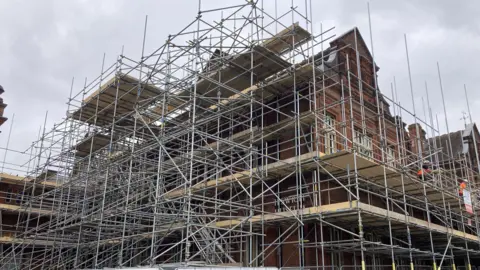 Steve Martin/BBC The exterior of Ipswich Museum covered in scaffolding during its renovation work.