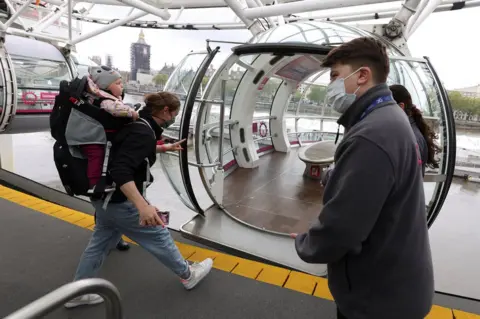 Tom Nicholson / Reuters Passengers board the London Eye