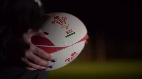 A player holding a rugby ball