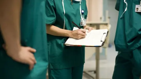 Getty Images Surgeons in operating theatre