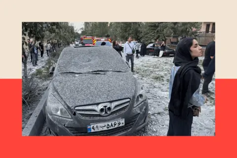 Getty Images People look over the aftermath of an Israeli airstrike that destroyed buildings in Tehran, Iran, on 13 June 2025