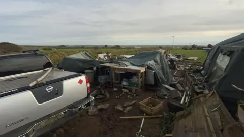 Noon Cregg CIC A general view of the retreat showing a silver truck parked next to a variety of belongings strewn all over the place.