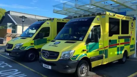 BBC Two ambulances parked next to each other, they are large and square.