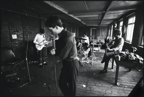 Kevin Cummins The band at TJ Davidson's rehearsal rooms, Little Peter Street, Manchester, 19 August 1979