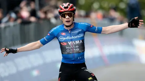 Jonas Vingegaard spreads his arms out as he celebrates winning stage nine of the Giro d'Italia