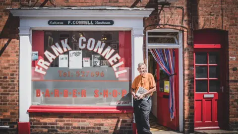 Rachel London Photography Frank Connell outside his shop on Burton Road, Lincoln