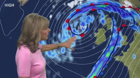 Louise Lear stood in front of weather map