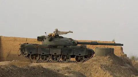 A tank near a wall along the border in Chaman, Pakistan.