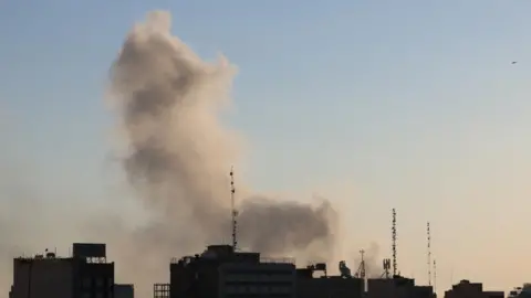 Smoke rises after an airstrike in central Tehran, Iran