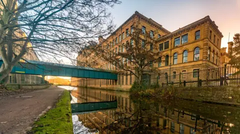 Getty Images A canal, a mill and a bridge over the canal. Its is an autumn day.