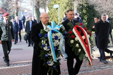 EPA The presidents of Israel and Poland lay wreaths together