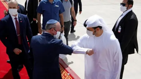 Reuters Israeli National Security Adviser Meir Ben-Shabbat elbow bumps with an Emirati official at Abu Dhabi airport in the United Arab Emirates (1 September 2020)