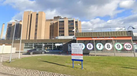 Google The main entrance to Raigmore with signage, including ones showing numbers and colours of different zones in the hospital. 