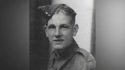 Grainy black and white image of Pvt Clayton looking at the camera. He is wearing his army uniform. 