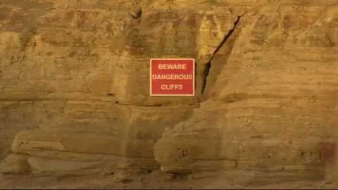 Warning sign on cliffs