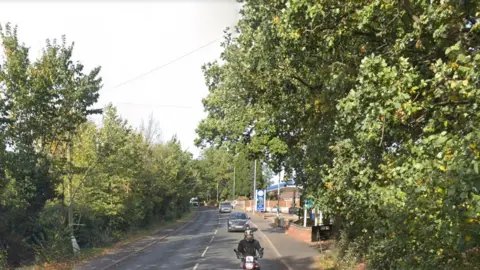 Fakenham Road in Taverham, showing filling station to the right