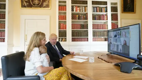 Andrew Parsons / No10 Downing Street Boris Johnson, Carrie Symonds and baby Wilfred on video call with midwives