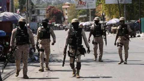 Reuters Police patrol a street in Port-au-Prince, Haiti
