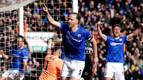 PA Media Jamie Grimes celebrates a goal