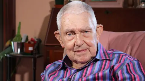 A man in a colourful striped shirt