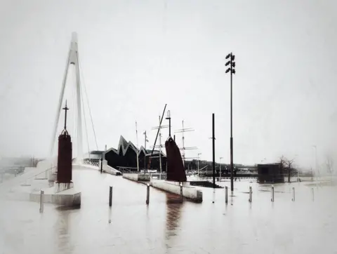 William Dyer A black and white image on a rainy day of the Govan footbridge with the Riverside museum in the distance