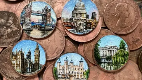 Coins with painted miniatures of famous landmarks. In the photo there are a mix of painted and unpainted coins