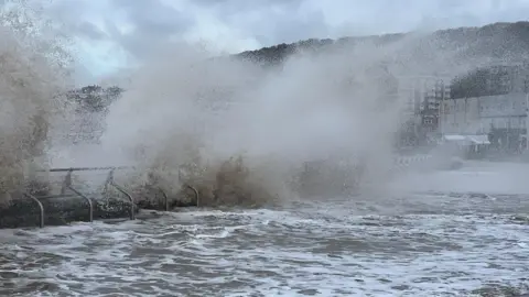 A wave breaks on a sea wall in Weston-super-Mare.