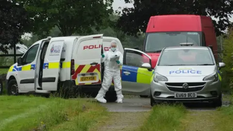 John Fairhall/BBC Police cars and van