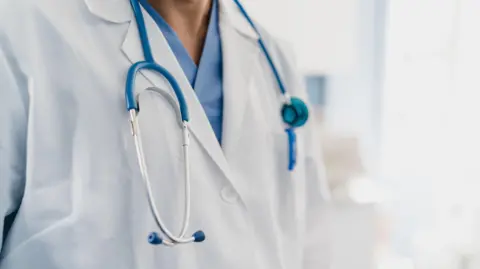 Getty Images Close-up of a doctor's gown with stethoscope