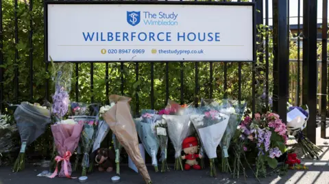 Reuters Floral tributes were left outside the school days after the crash