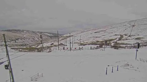 DOI A view from the mountain, you can see snow covering it.