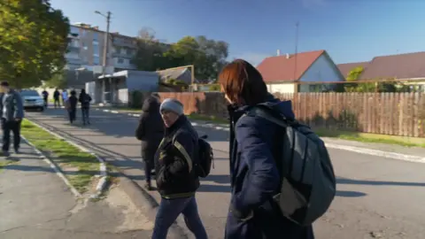 Sarah Rainsford speaks to a woman who is angry after failing to receive 1,000 roubles for her vote.