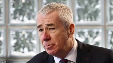 Getty Images A man with short grey hair, black eyebrows and is wearing a suit.
