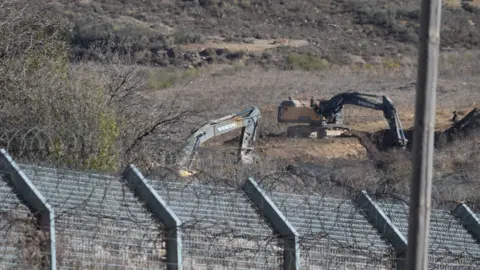 BBC Excavators dig trenches near Majdal Shams, in the Israeli-occupied Golan Heights