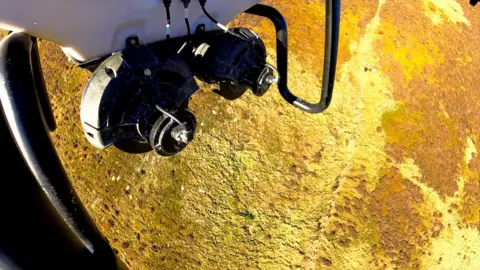 Scottish Water An aerial view of a drone scattering seed over a landscape in south of Scotland