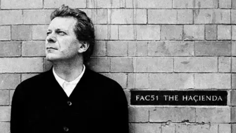 Tony Wilson as photographed by Paul Wolfgang Webster in 1996 in front of the former Hacienda nightclub
