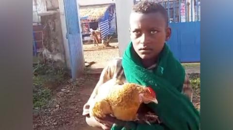 Markos Abaye holding his chicken