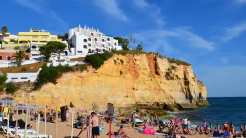 Getty Images Tourists in the beach in Carvoeiro, Algarve, Portugal