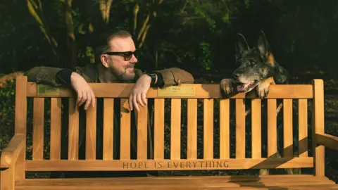 Netflix Ricky Gervais and dog with bench