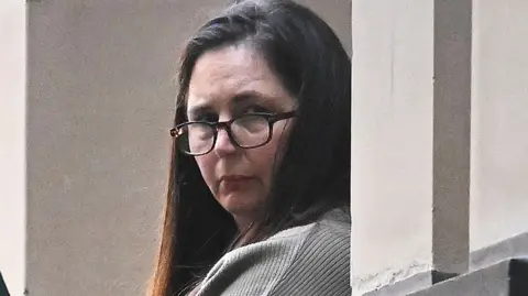 Erin Patterson during trial in Melbourne wearing glasses and her dark her down.
