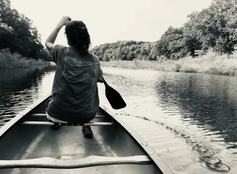 Matthew Logan A person paddling in a canoe