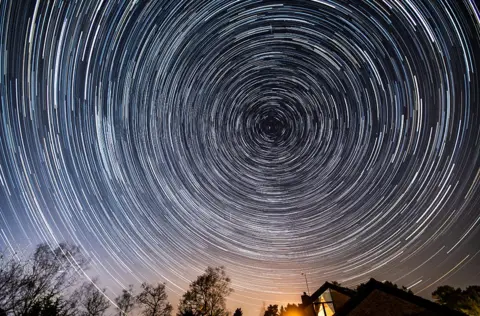 Nick Lucas / SWNS Star trail over Ringwood, Hampshire - also seen are a number of small meteors