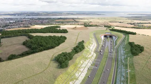 National Highways A graphic of the Lower Thames Crossing, which shows multiple lanes of traffic in both directions going into a tunnel beneath the River Thames. The road is surrounded by fields either side of the water.