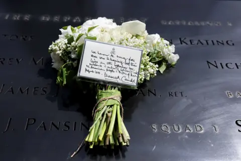 Reuters A bouquet of flowers with a note from Britain’s King Charles and Queen Camilla lies at the 9/11 Memorial, during their state visit to the United States, in New York City, U.S., April 29, 2026.