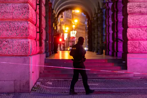 EPA A police officer patrols following a mass shooting at one building of the Charles University in central Prague, Czech Republic, 22 December 2023.