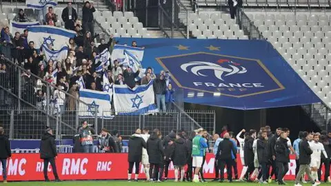 AFP Israel coach Ran Ben Simon celebrates with his players and fans after the UEFA Nations League 2024/25 League A Group A2 match between France and Israel at Stade de France on November 14, 2024 in Paris, France. 