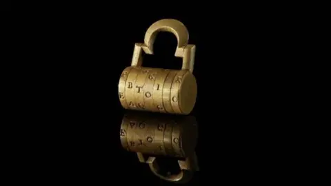 Amgueddfa Cymru A gold combination lock