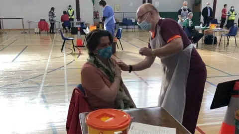 RTÉ NI First Minister Arlene Foster receiving her first AstraZeneca jab at the Castle Park leisure centre in Lisnaskea