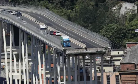 AFP/Getty Images A picture of the Morandi motorway bridge showing the missing area and vehicles close to the edge